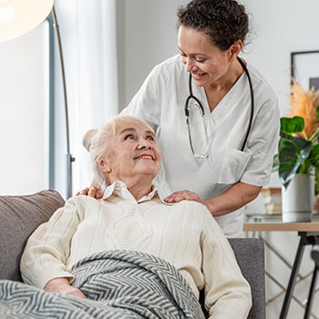 Senior Female On Couch With Nurse |